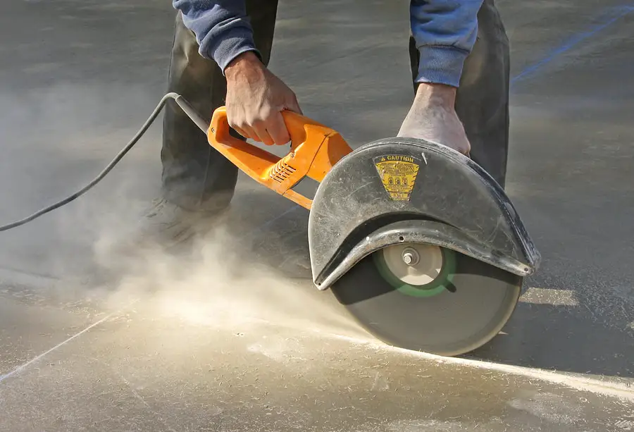 Professional concrete cutting with diamond blade saw in action